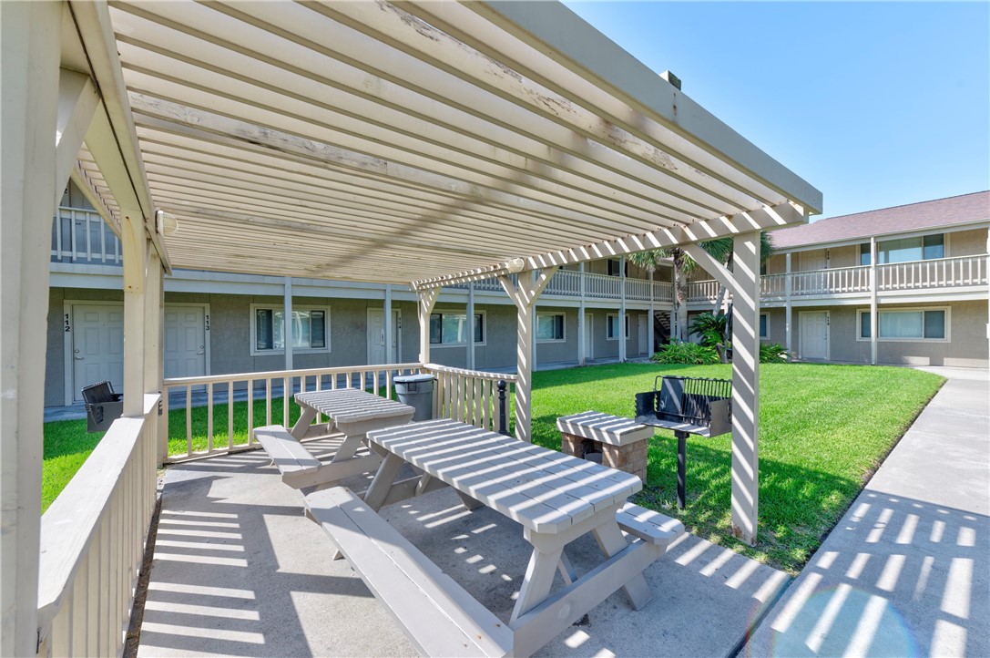 622 Beach Access Rd- 1a, Unit 231 Port Aransas, TX 78373 - Photo 23 of 24 a view of a house with a backyard