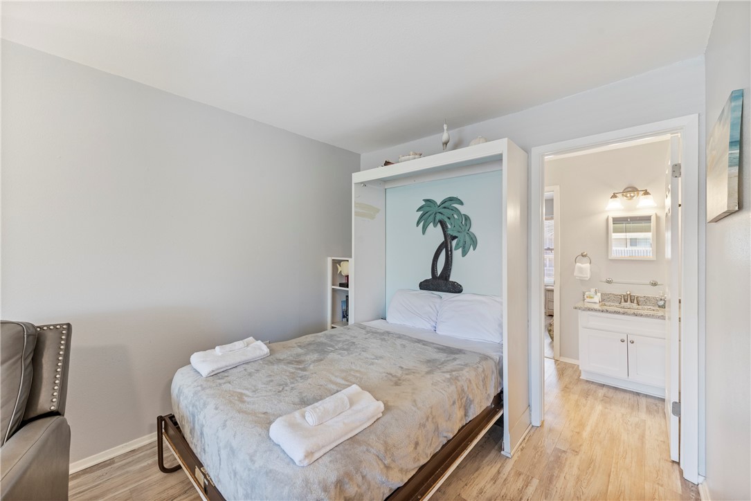 622 Beach Access Rd- 1a, Unit 231 Port Aransas, TX 78373 - Photo 8 of 24 a bedroom with a bed and a table
