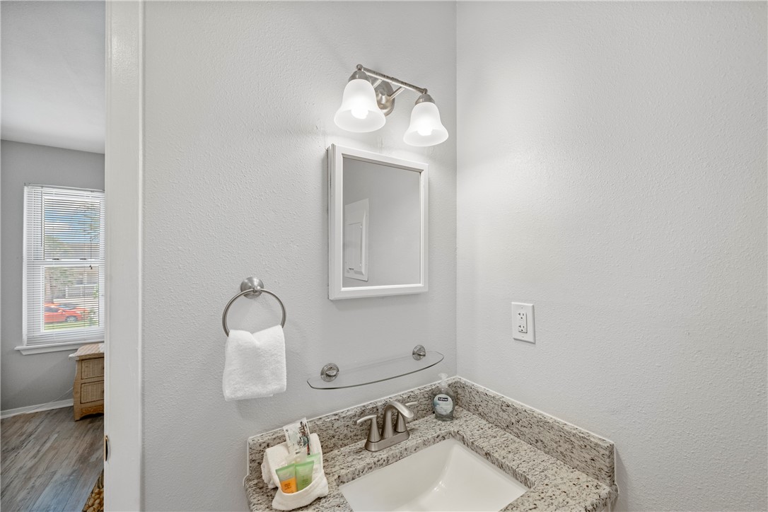 622 Beach Access Rd- 1a, Unit 231 Port Aransas, TX 78373 - Photo 9 of 24 a bathroom with a sink and a mirror