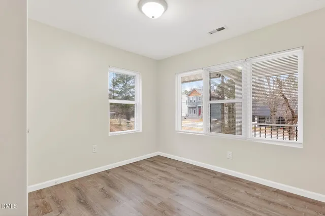a view of a room with wooden floor and a chandelier