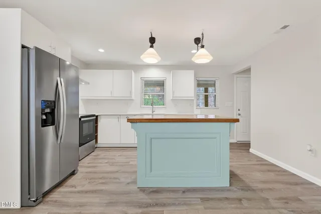 a kitchen with stainless steel appliances a stove and a refrigerator