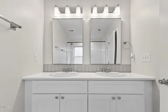 a view of a small space with wooden floor and a window