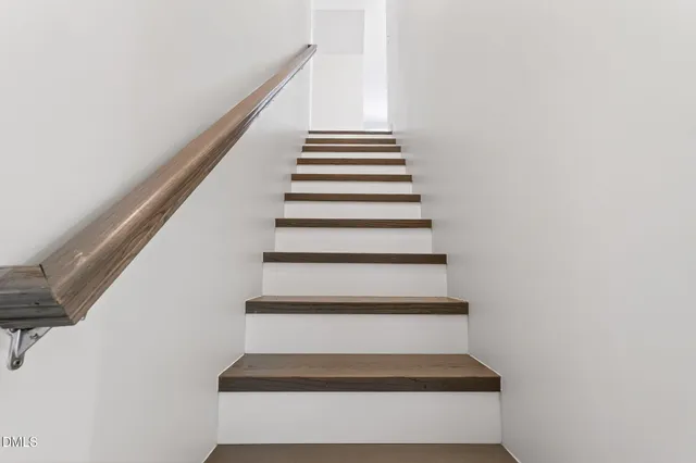 a view of bathroom with a toilet a sink and a mirror