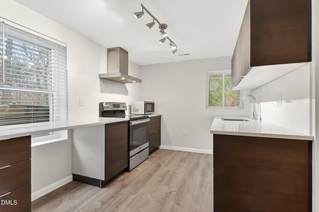an aerial view of a house with large trees in front of it