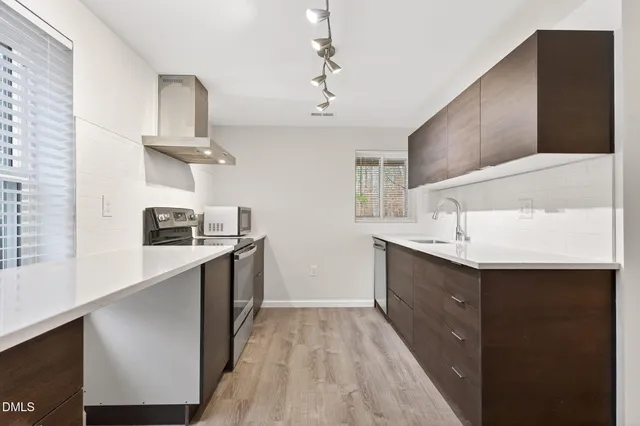 an aerial view of a house with large trees