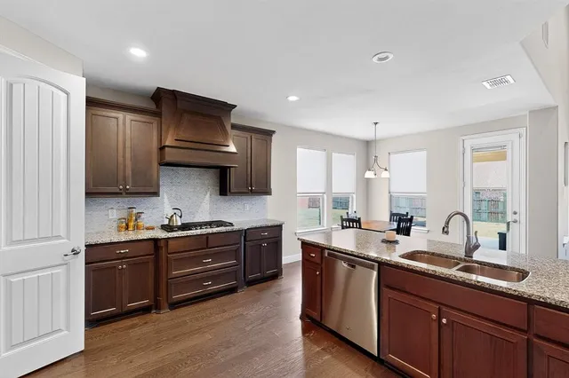a kitchen with sink stove and cabinets