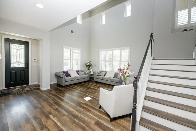 a kitchen with a table chairs refrigerator and window