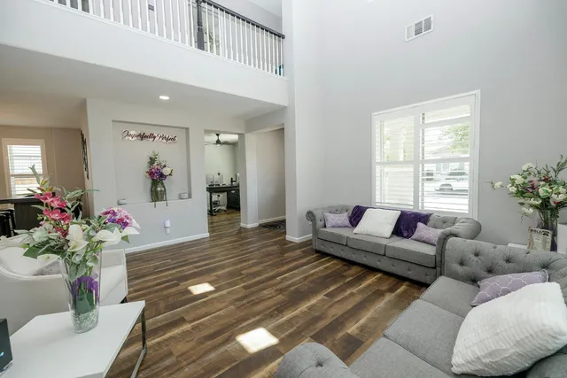 a living room with furniture a fireplace and a flat screen tv