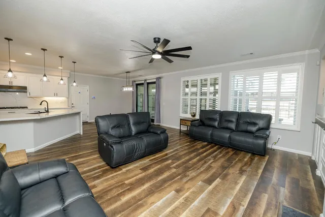 a view of a kitchen with a sink stainless steel appliances and cabinets
