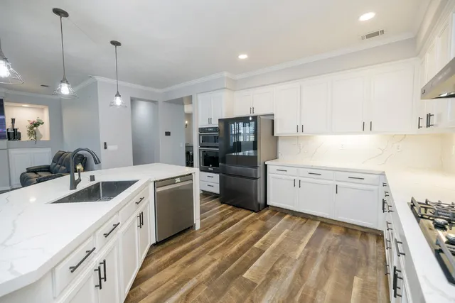 a view of a hallway with wooden floor and staircase