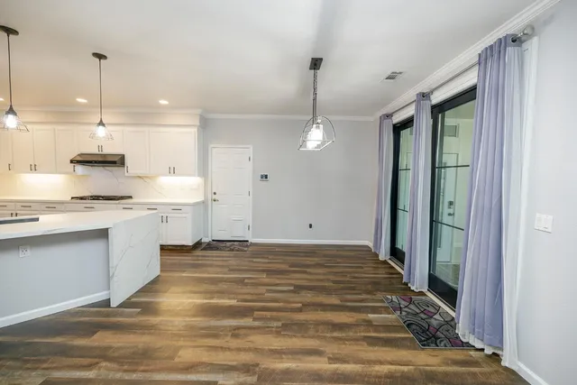 a spacious bathroom with a granite countertop sink mirror and a bathtub
