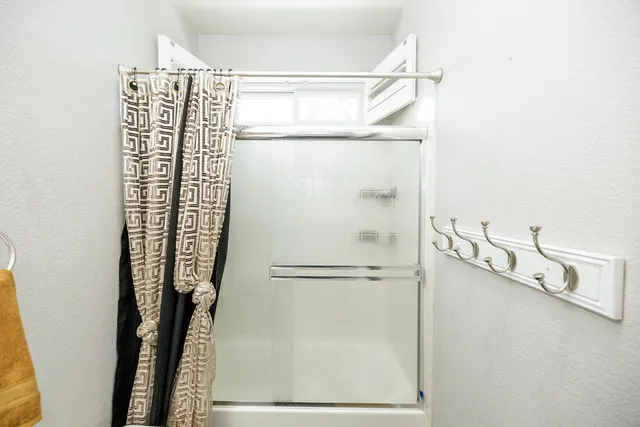 a large bed sitting in a bedroom next to a window