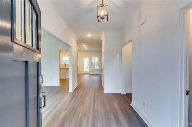 a view of hallway with wooden floor