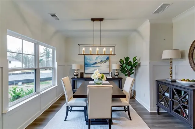 a dining room with furniture a chandelier and wooden floor