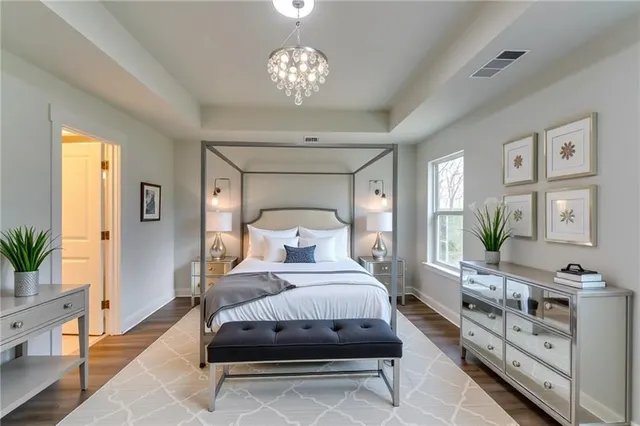 a bedroom with a bed and a chandelier