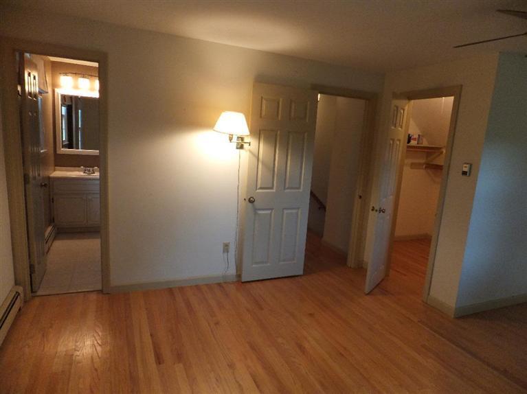 14 Brick Hill Road Orleans, MA 02653 - Photo 18 of 27 wooden floor in an empty room with a mirror