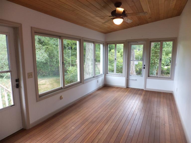 14 Brick Hill Road Orleans, MA 02653 - Photo 5 of 27 a view of an empty room with wooden floor and a window