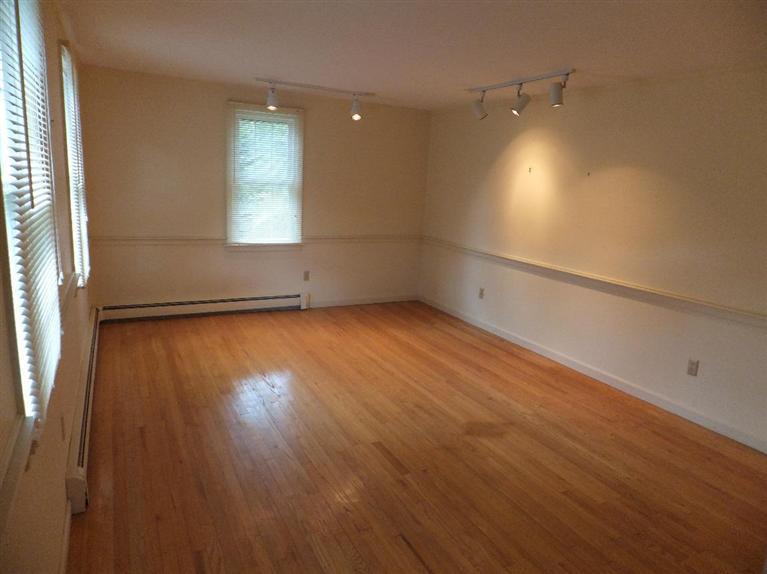 14 Brick Hill Road Orleans, MA 02653 - Photo 9 of 27 an empty room with wooden floor and windows