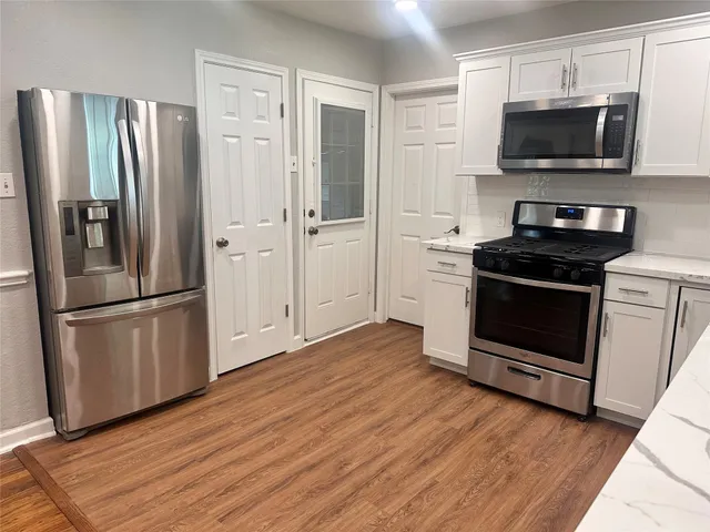a kitchen with a refrigerator stove and microwave