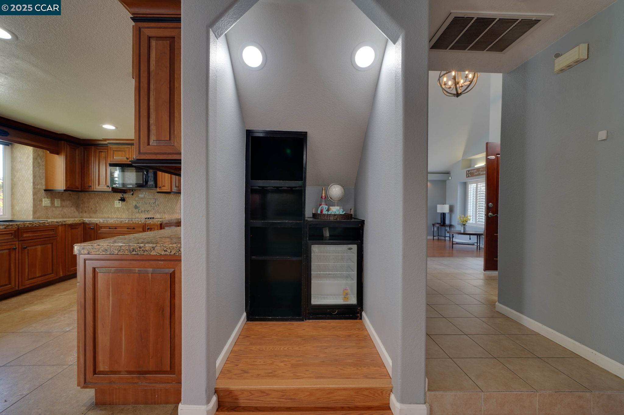 1210 Snow Ridge Court Modesto, CA 95351 - Photo 14 of 43 a kitchen with granite countertop a refrigerator and a sink