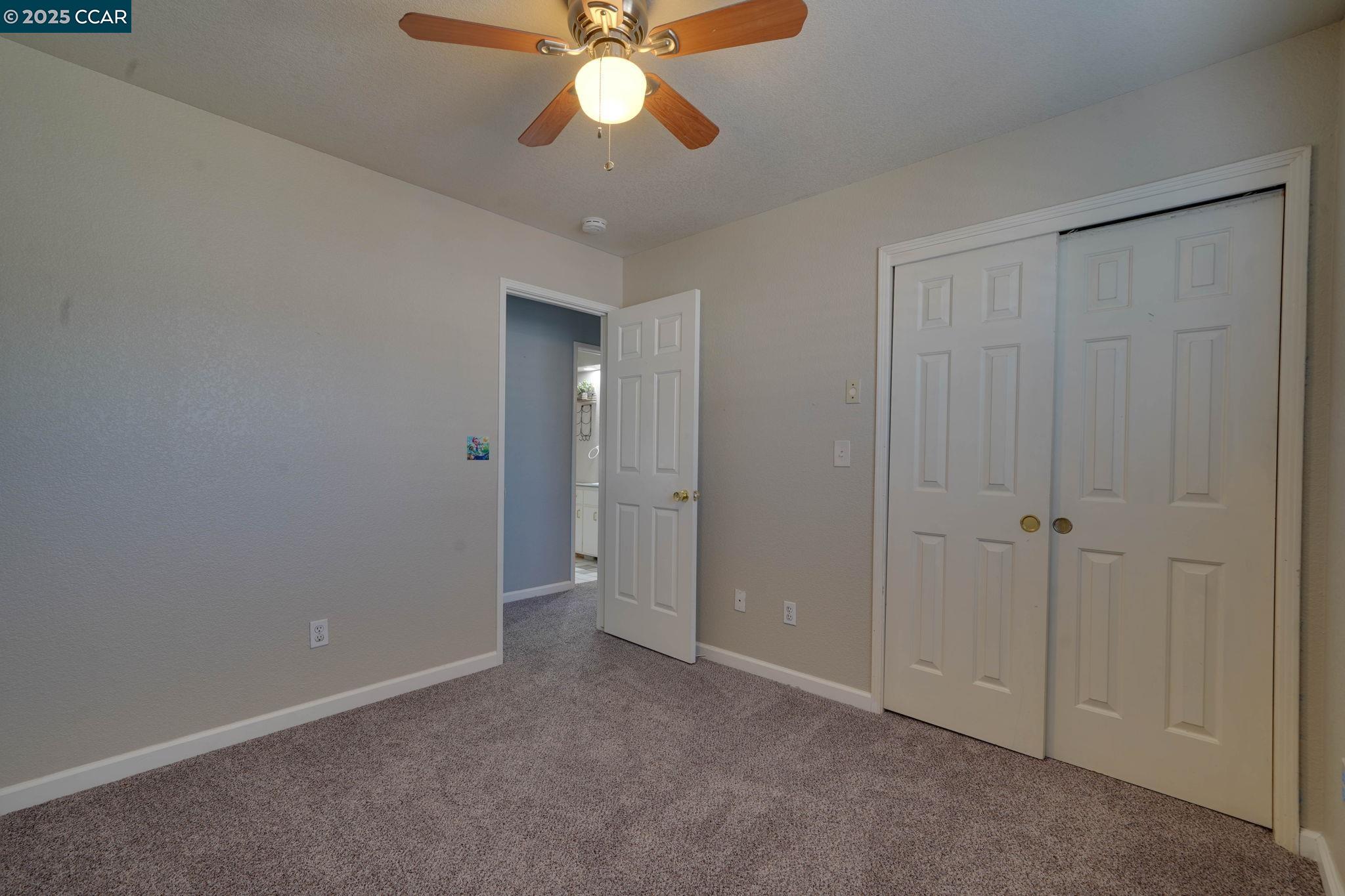 1210 Snow Ridge Court Modesto, CA 95351 - Photo 34 of 43 a view of an empty room and chandelier fan