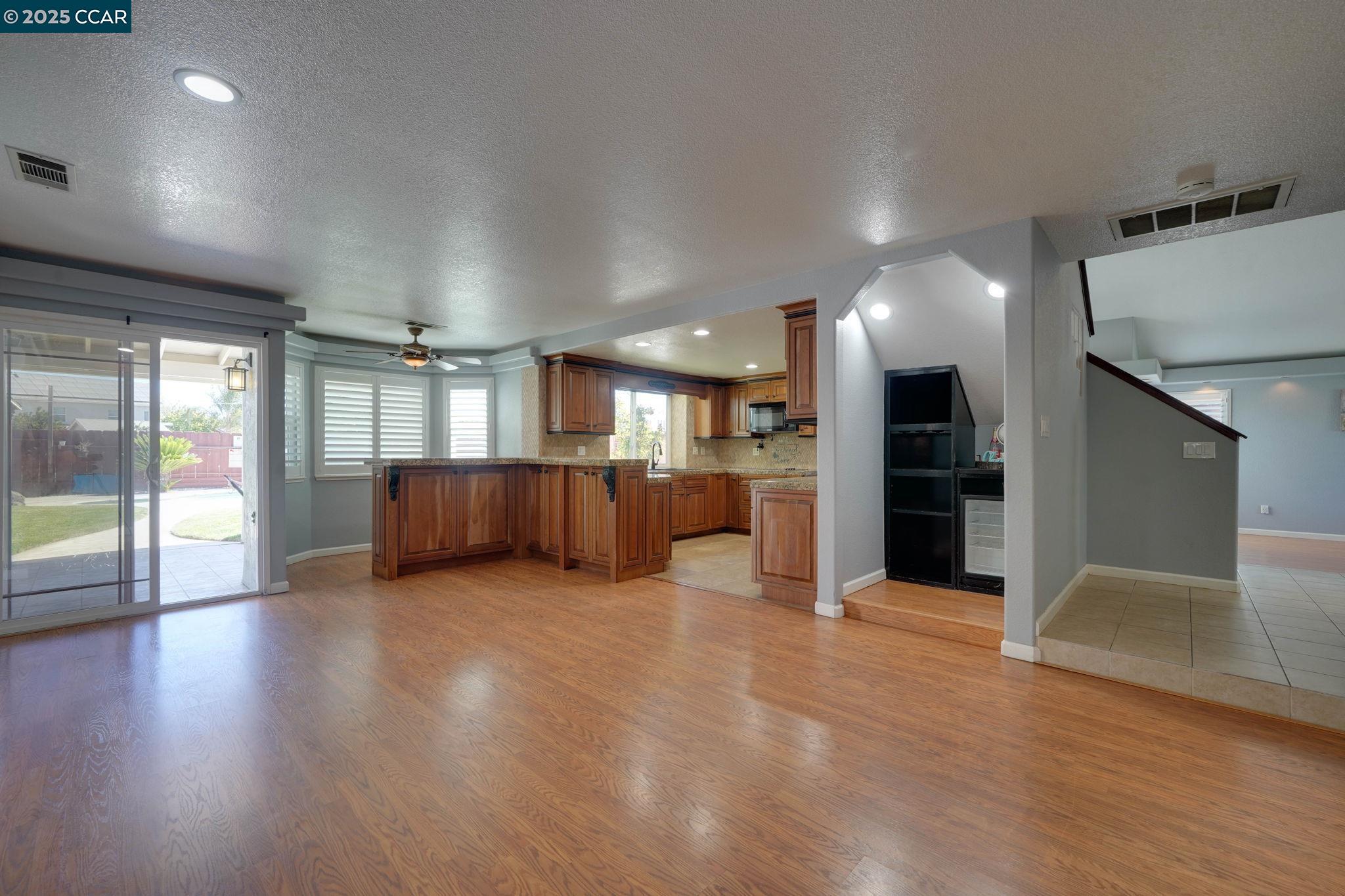 1210 Snow Ridge Court Modesto, CA 95351 - Photo 8 of 43 a view of a big room with wooden floor and windows