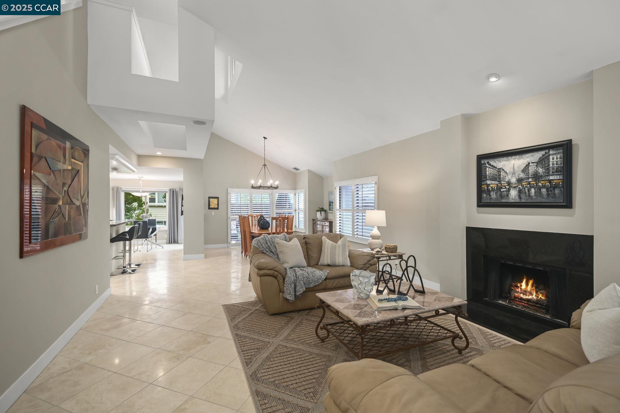 a living room with furniture large window and a fireplace