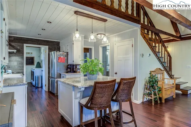 a bedroom with a bed and a dresser next to a window