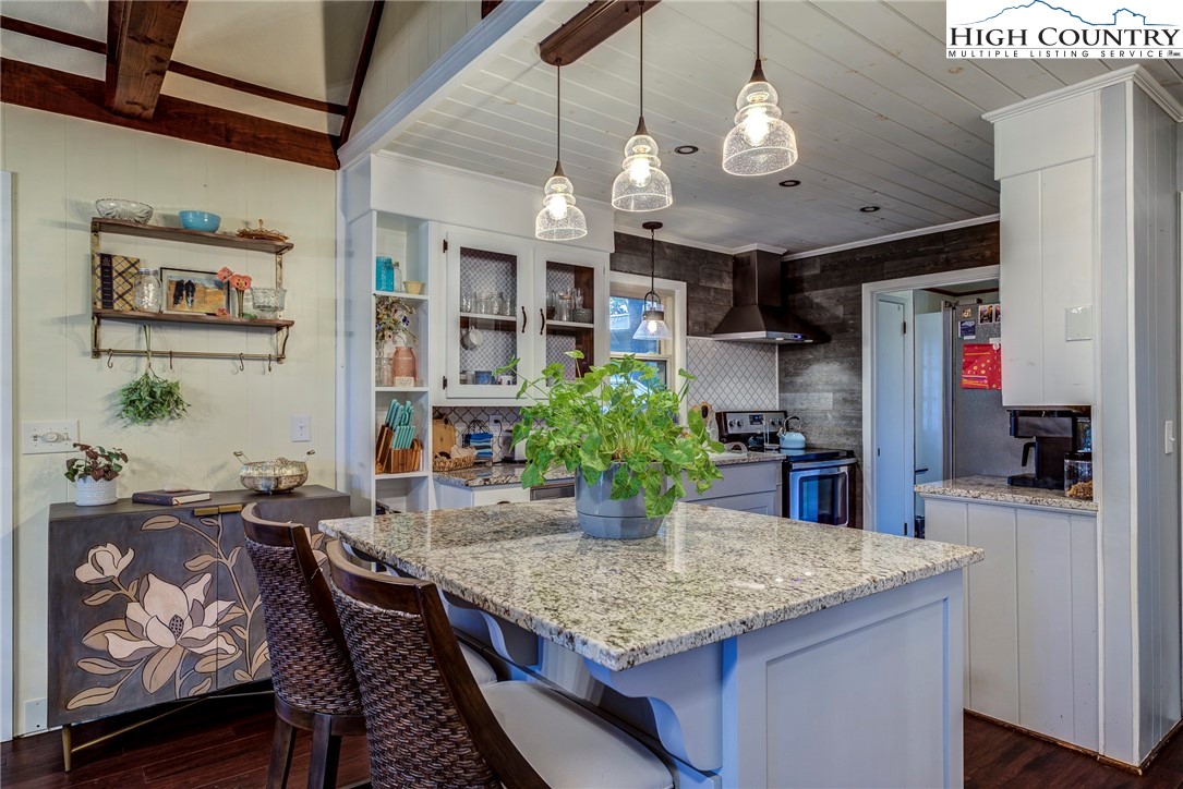 528 Bear Ridge Trail Fleetwood, NC 28626 - Photo 16 of 44 a kitchen with stainless steel appliances granite countertop a kitchen island a stove and a dining table