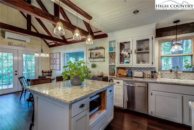 a living room with furniture and a glass door