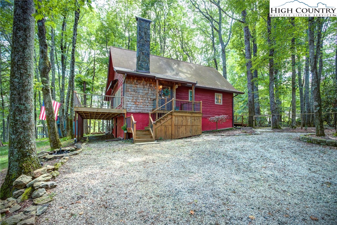 528 Bear Ridge Trail Fleetwood, NC 28626 - Photo 2 of 44 a view of backyard with wooden fence and a large tree