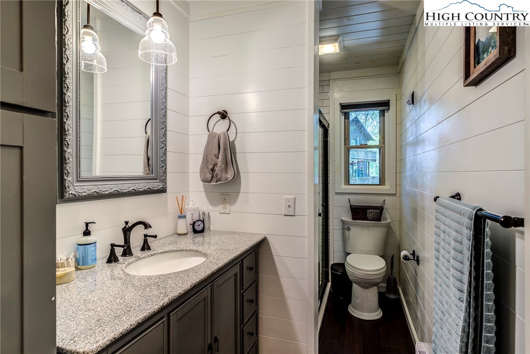 528 Bear Ridge Trail Fleetwood, NC 28626 - Photo 28 of 44 a bathroom with a granite countertop sink toilet and shower