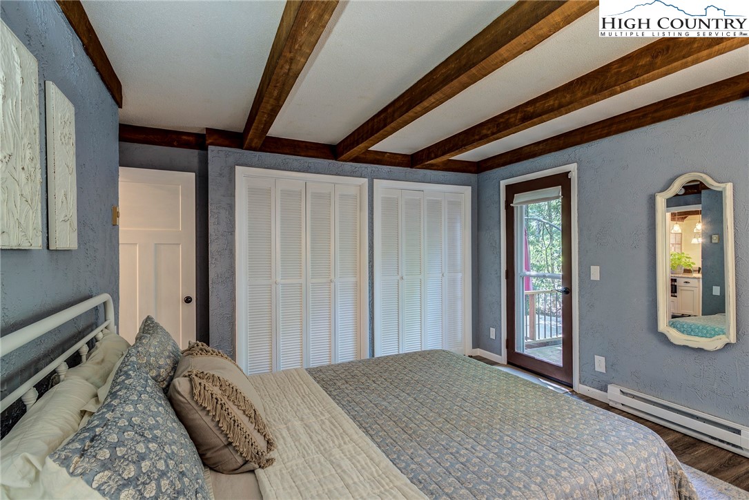 528 Bear Ridge Trail Fleetwood, NC 28626 - Photo 32 of 44 a bedroom with a bed and a dresser next to a window