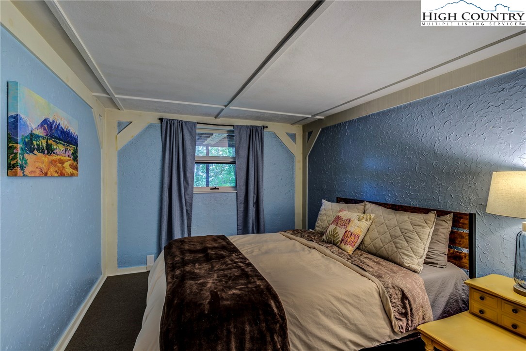 528 Bear Ridge Trail Fleetwood, NC 28626 - Photo 42 of 44 a bedroom with a bed and a painting on the wall