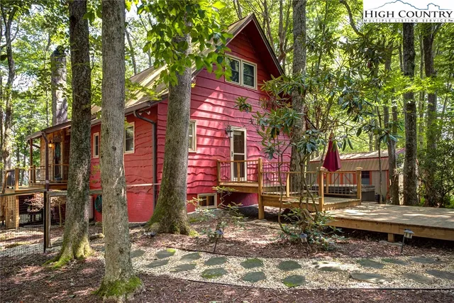 a living room with furniture fireplace and wooden floor