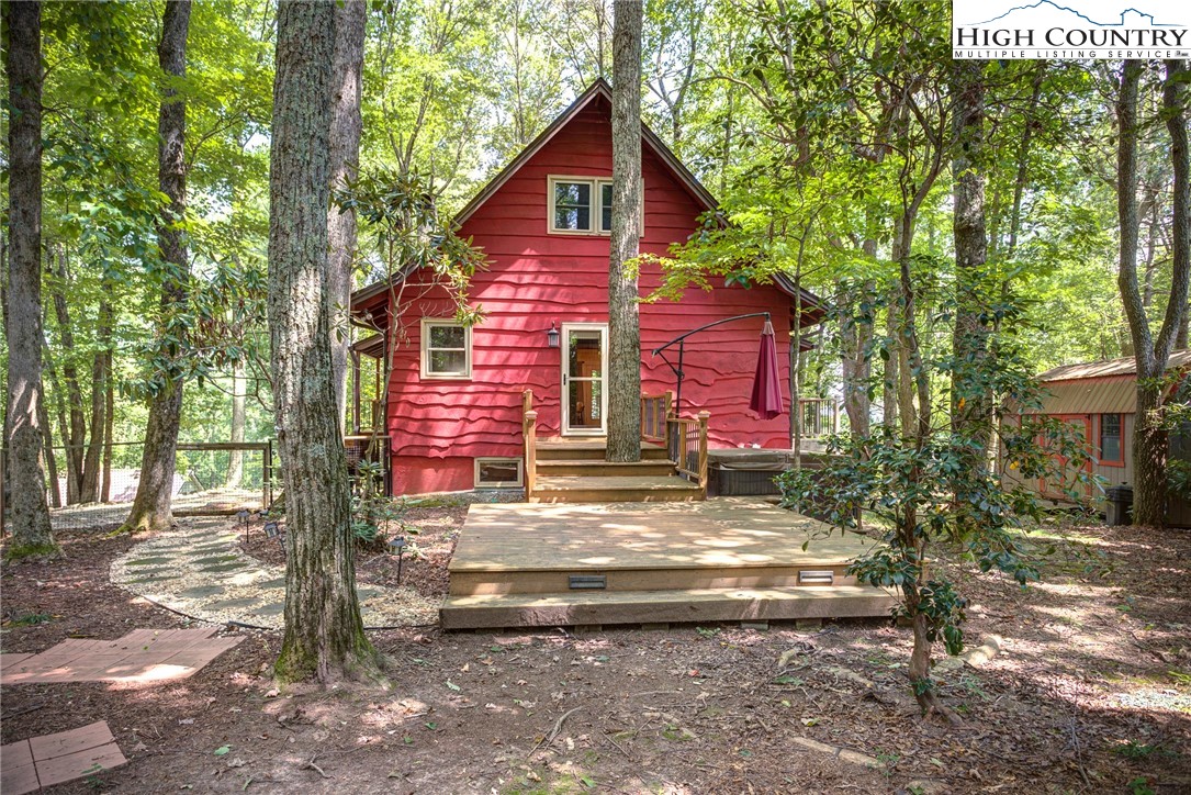 528 Bear Ridge Trail Fleetwood, NC 28626 - Photo 7 of 44 a view of brick house with large windows and a tree
