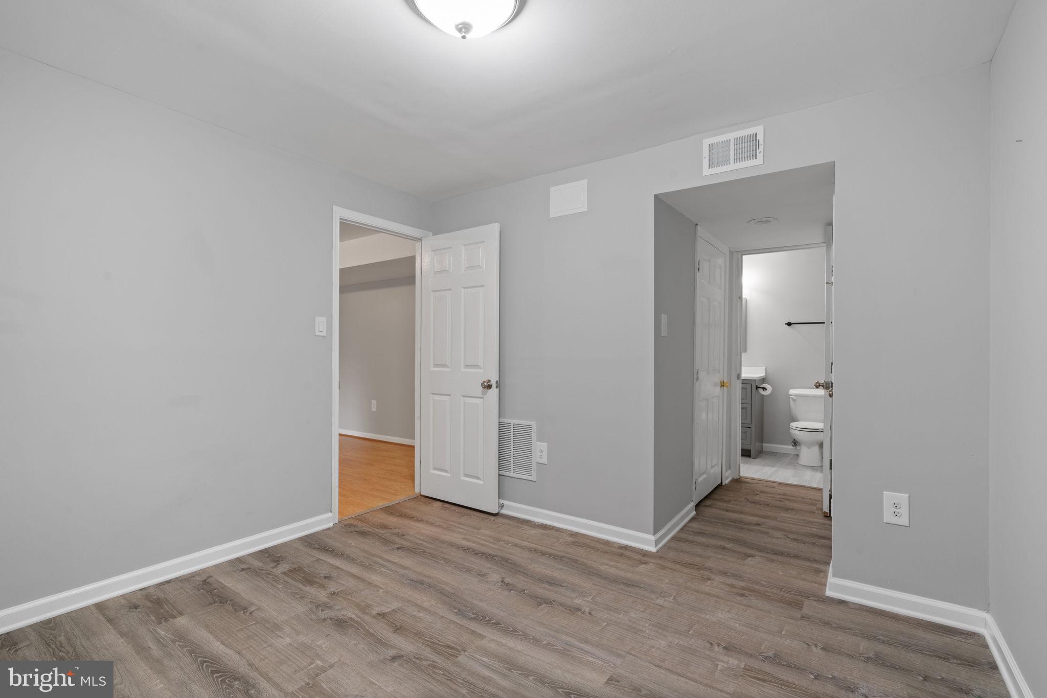 8527 Silverview Drive Lorton, VA 22079 - Photo 12 of 63 a view of wooden floor and a bathroom in back