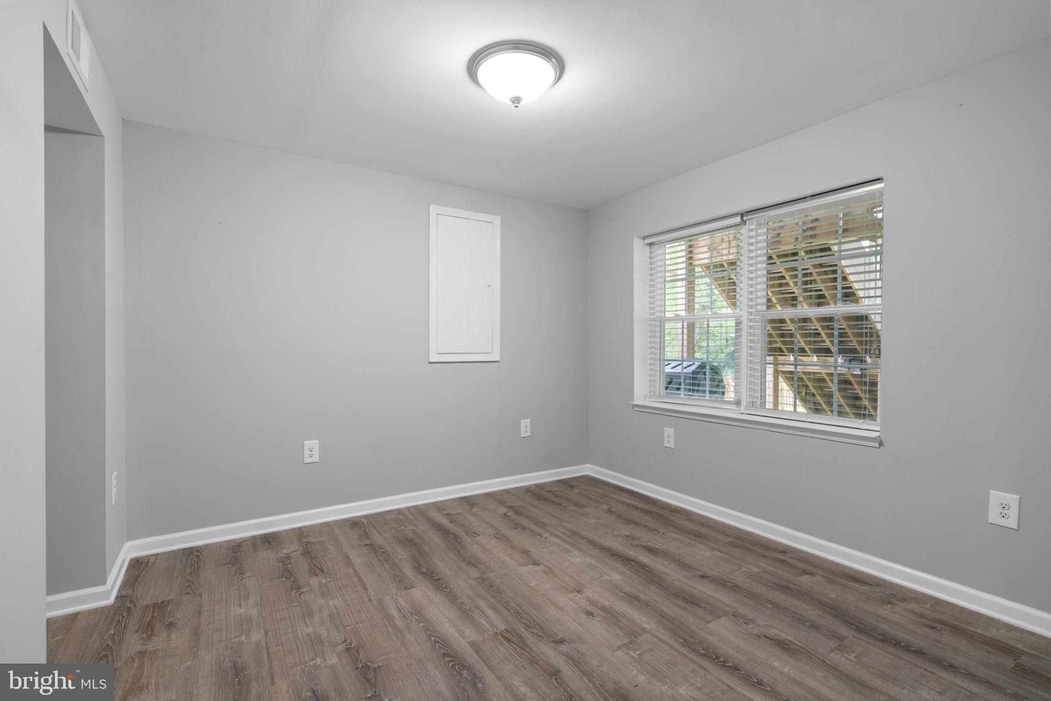 8527 Silverview Drive Lorton, VA 22079 - Photo 13 of 63 an empty room with wooden floor and windows