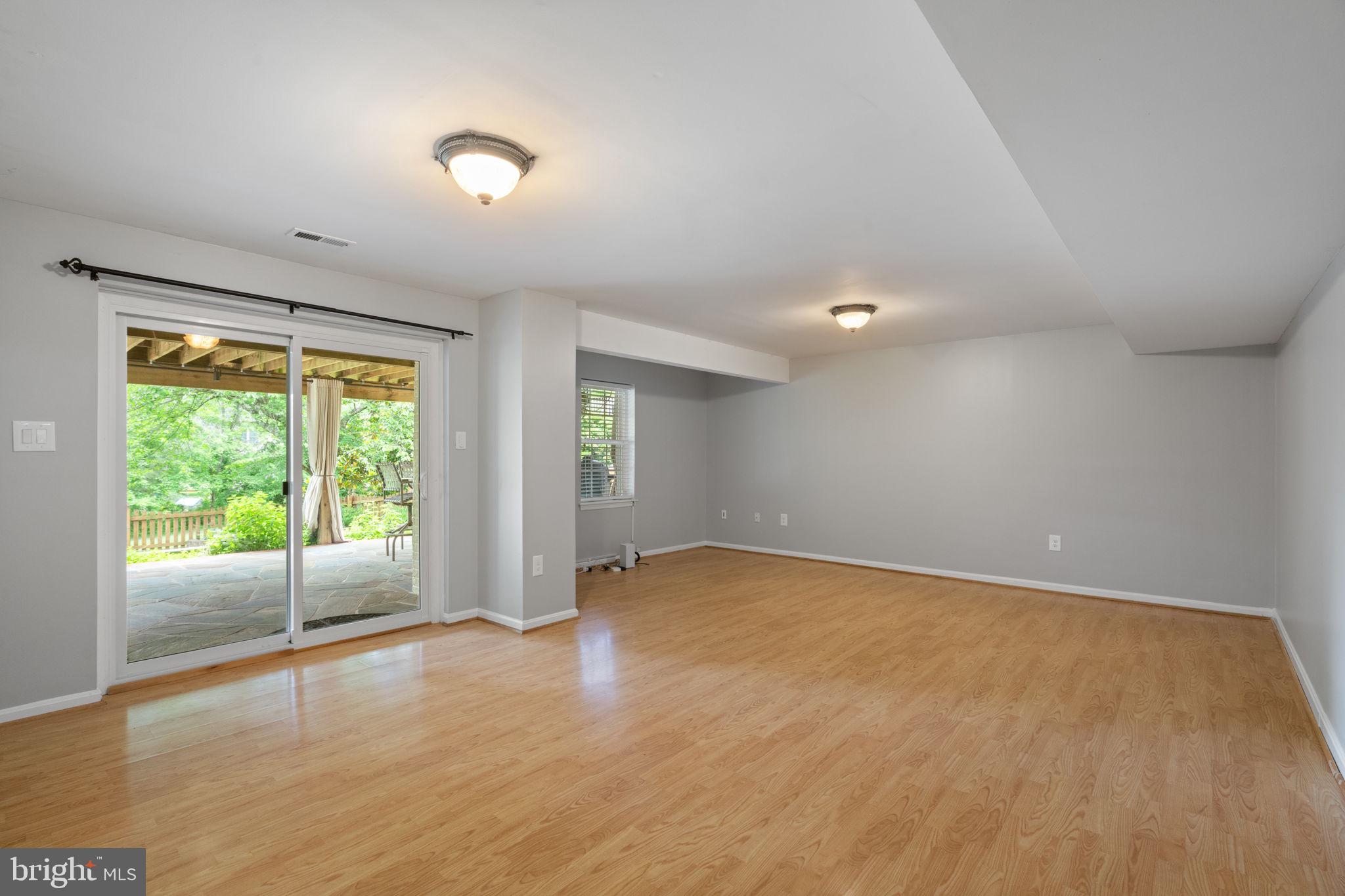 8527 Silverview Drive Lorton, VA 22079 - Photo 16 of 63 an empty room with wooden floor and windows