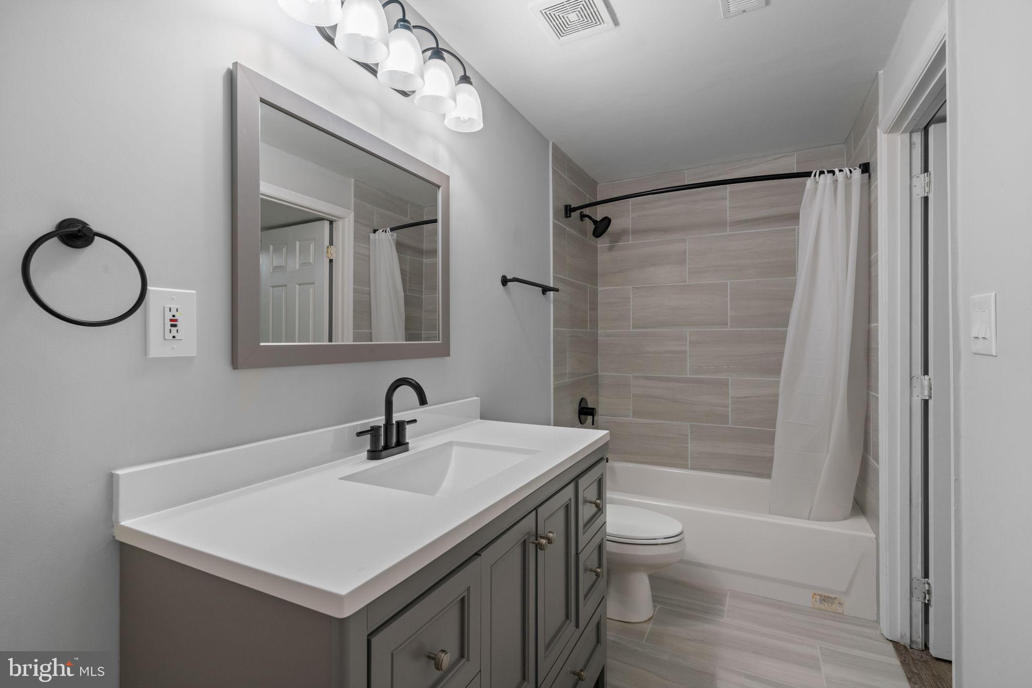 8527 Silverview Drive Lorton, VA 22079 - Photo 17 of 63 a bathroom with a sink a toilet a mirror and shower