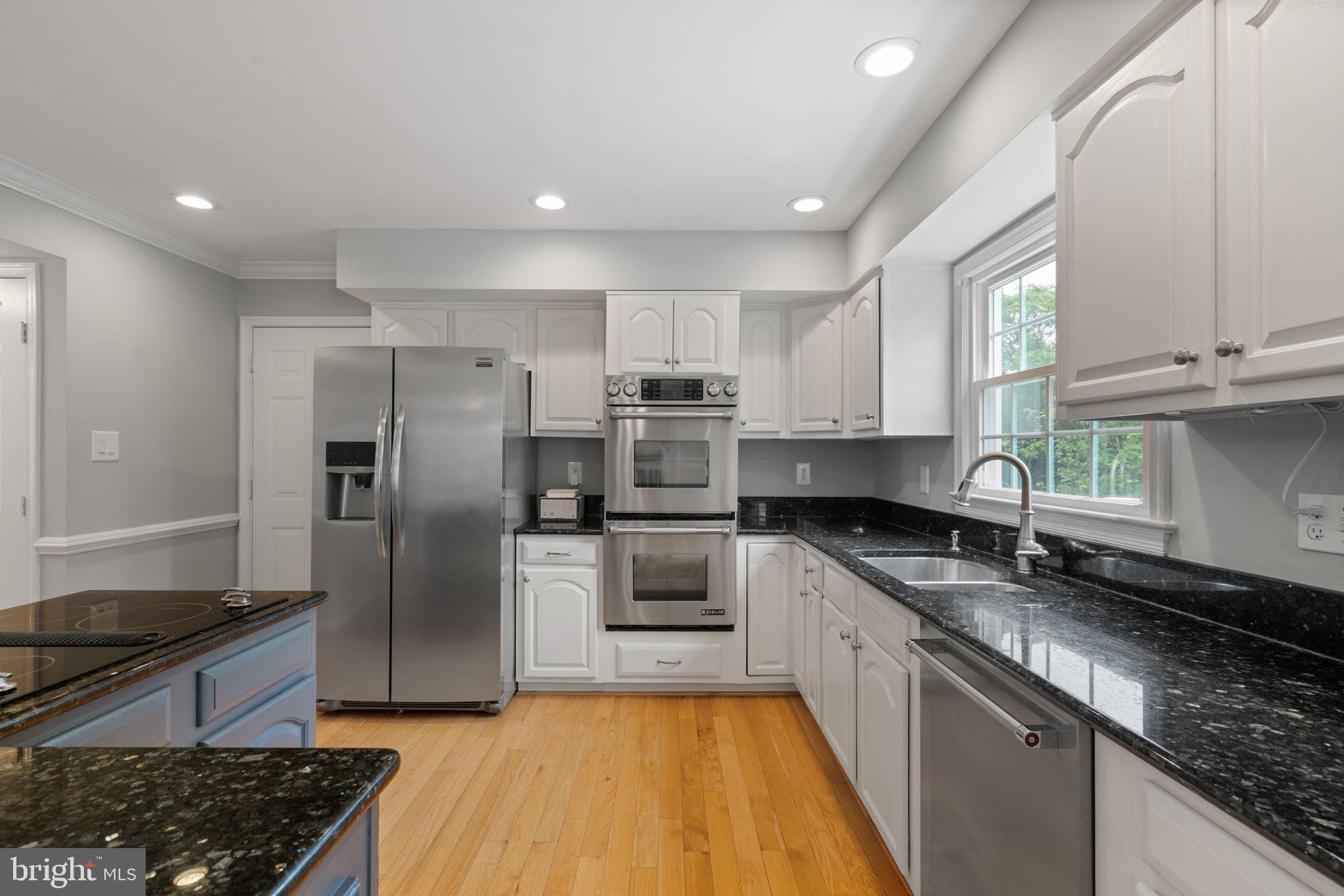 8527 Silverview Drive Lorton, VA 22079 - Photo 40 of 63 a kitchen with granite countertop a sink stainless steel appliances and cabinets