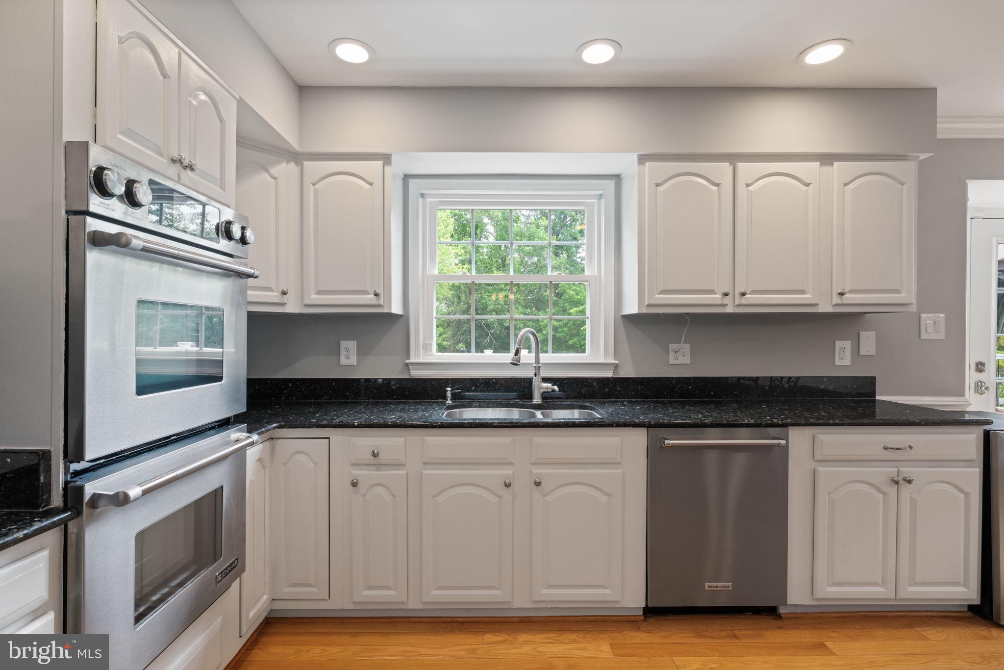 8527 Silverview Drive Lorton, VA 22079 - Photo 41 of 63 a kitchen with granite countertop white cabinets and appliances