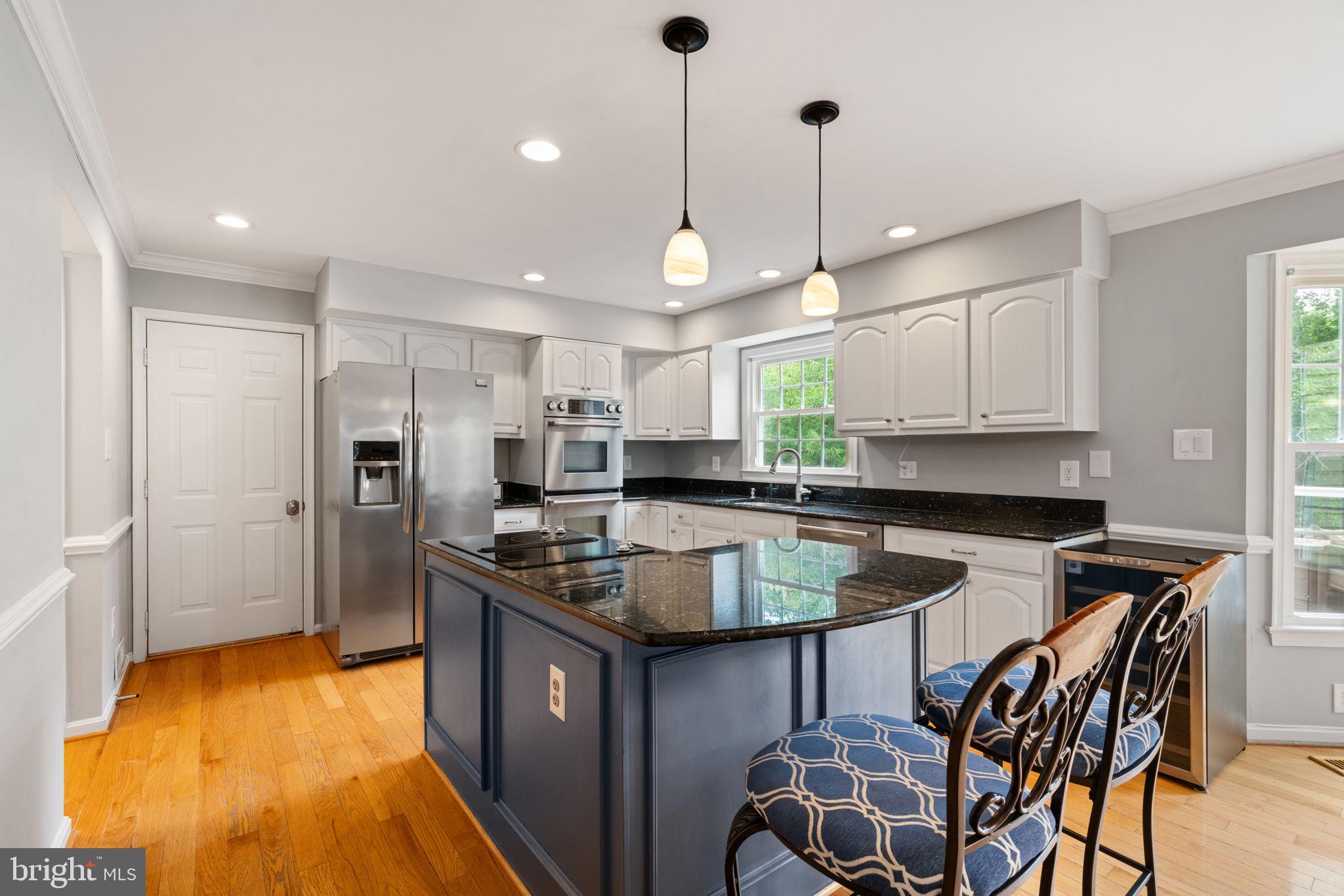 8527 Silverview Drive Lorton, VA 22079 - Photo 43 of 63 a kitchen with stainless steel appliances granite countertop a stove sink refrigerator and cabinets