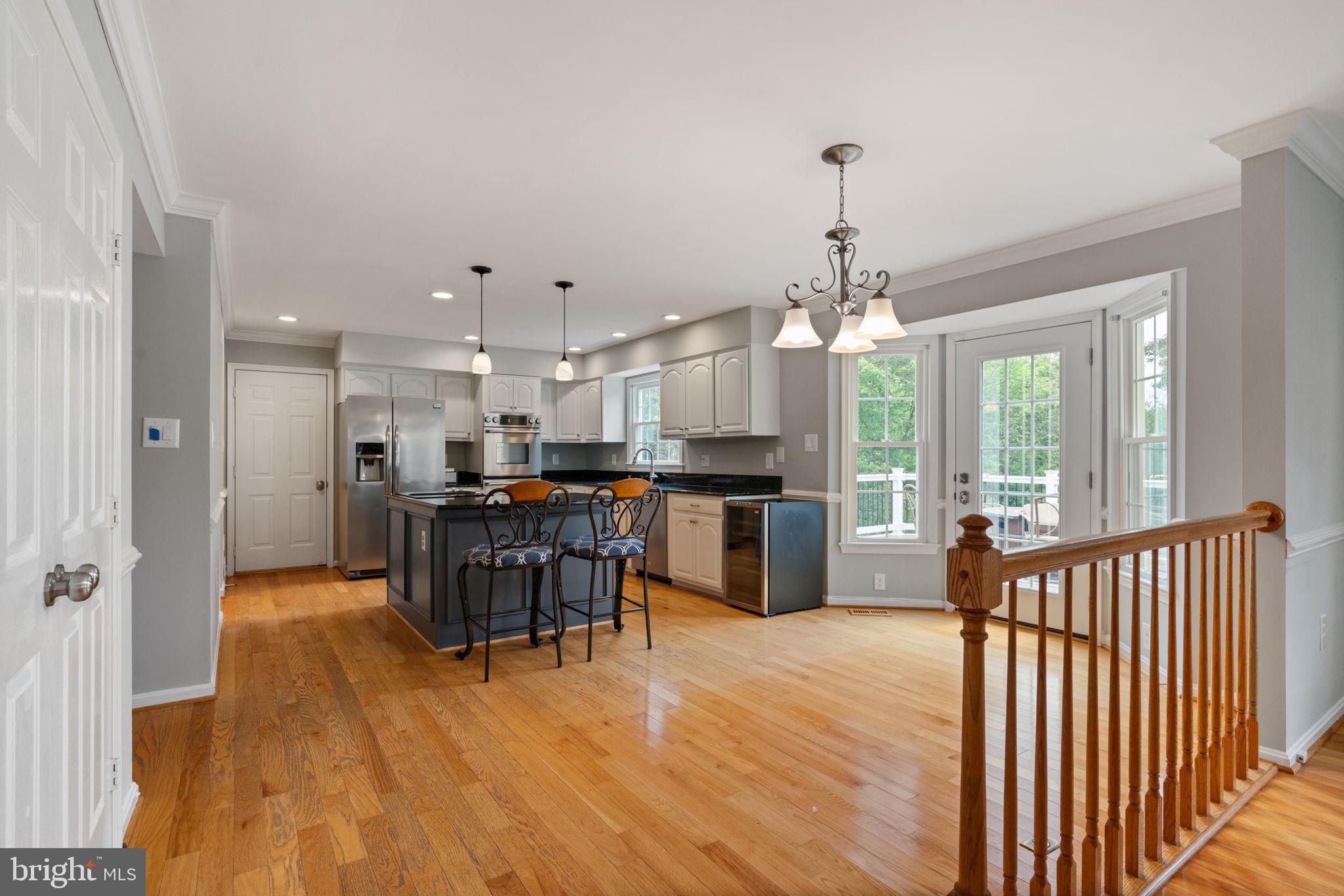 8527 Silverview Drive Lorton, VA 22079 - Photo 45 of 63 a view of a dining room and livingroom with furniture wooden floor a chandelier