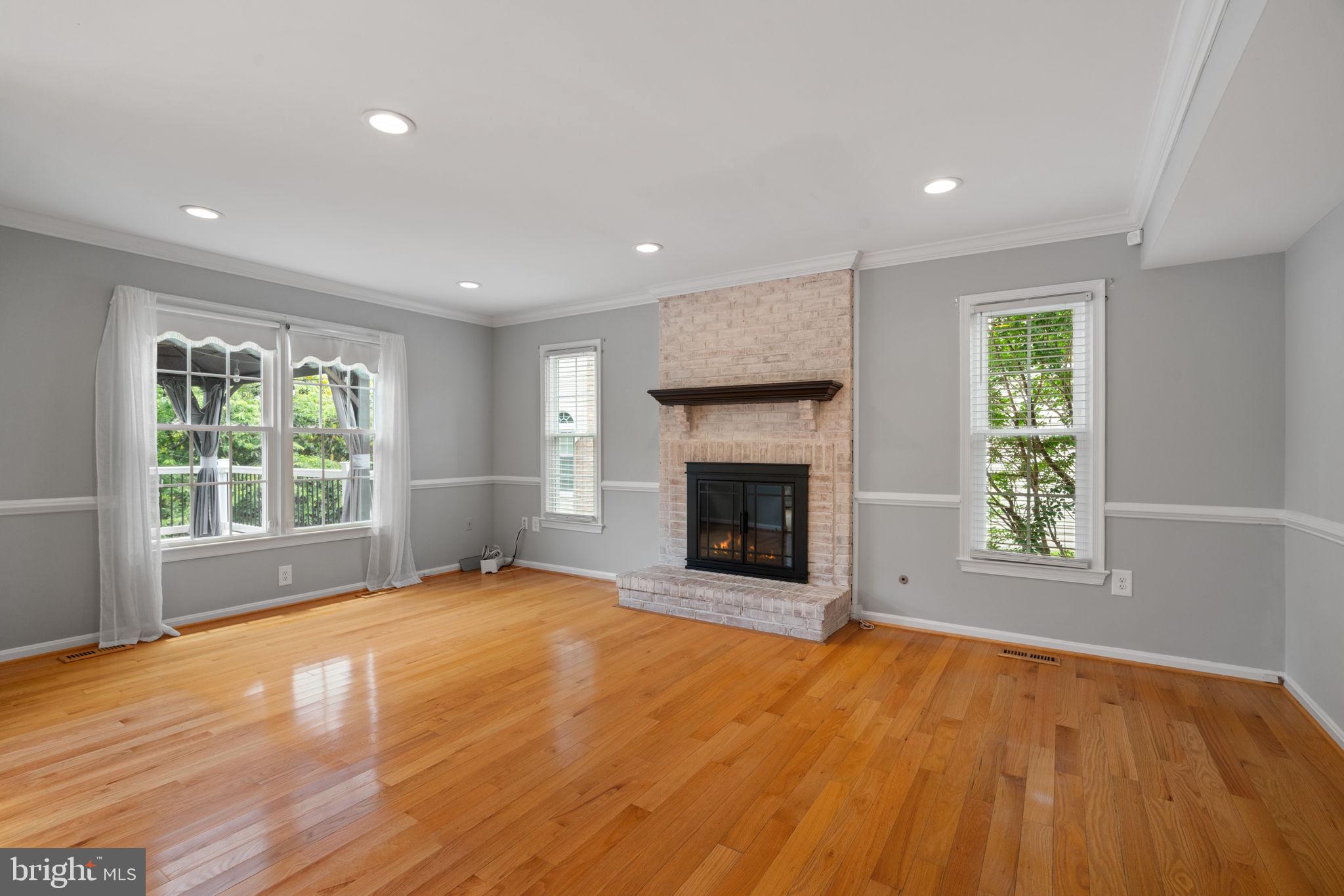 8527 Silverview Drive Lorton, VA 22079 - Photo 48 of 63 a view of empty room with a fireplace and wooden floor