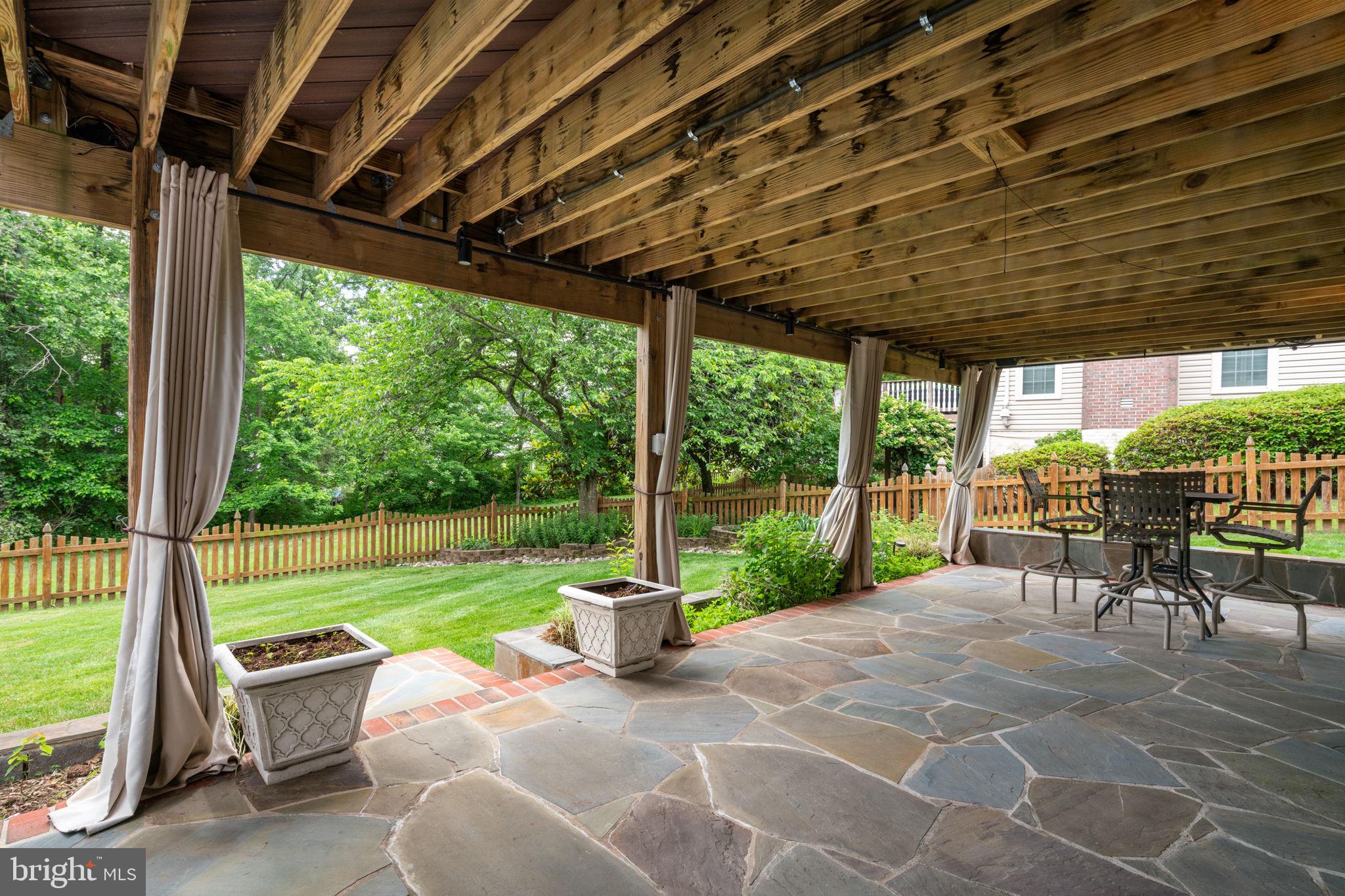 8527 Silverview Drive Lorton, VA 22079 - Photo 8 of 63 a view of a patio with a table chairs and a yard