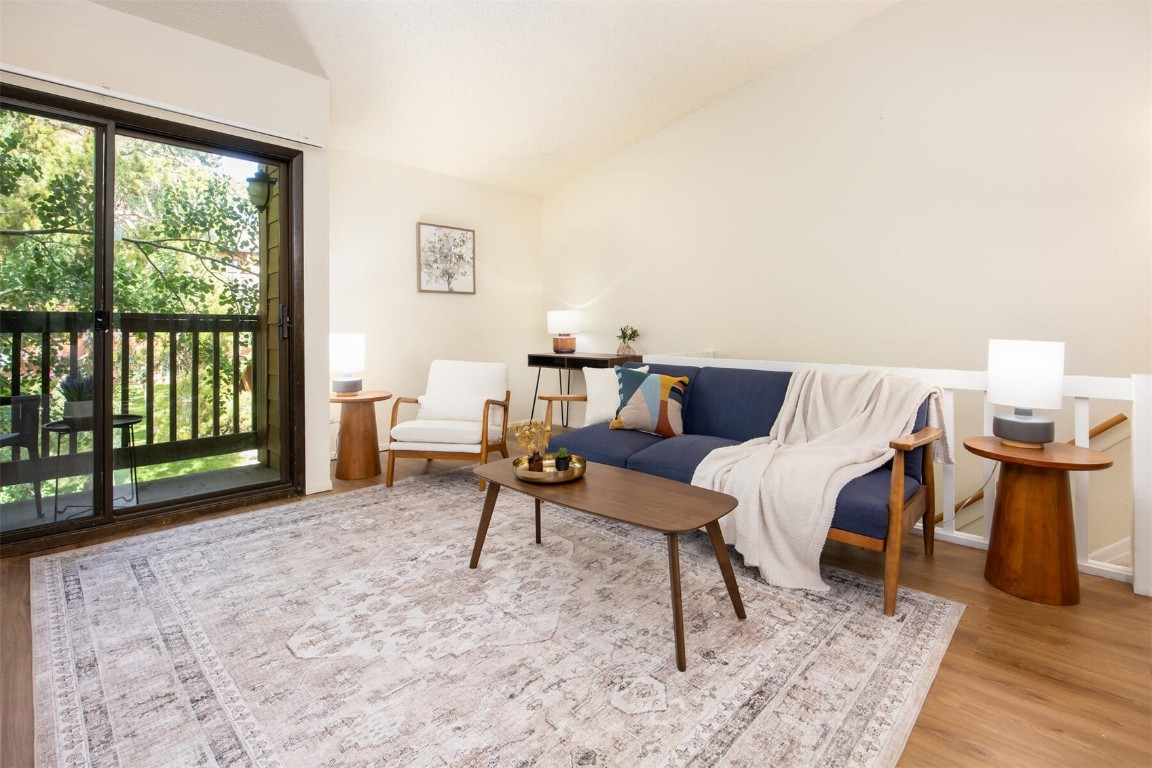 a living room with furniture and a floor to ceiling window
