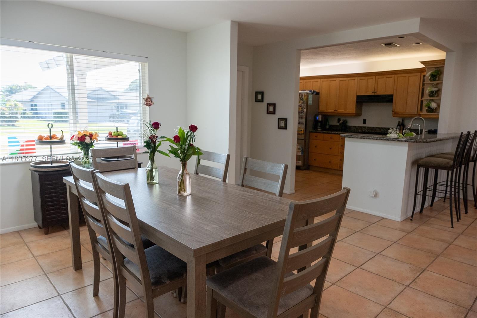 19663 Hampton Drive Boca Raton, FL 33434 - Photo 22 of 33 a view of a dining room with furniture and a large window
