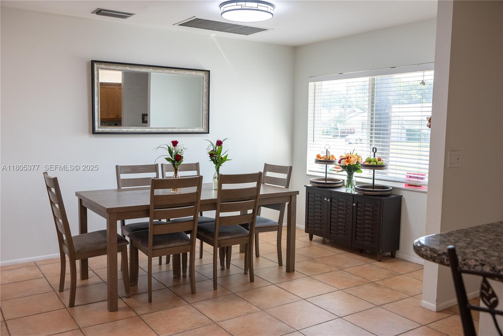 19663 Hampton Drive Boca Raton, FL 33434 - Photo 23 of 33 a dining room with a wooden table and chairs