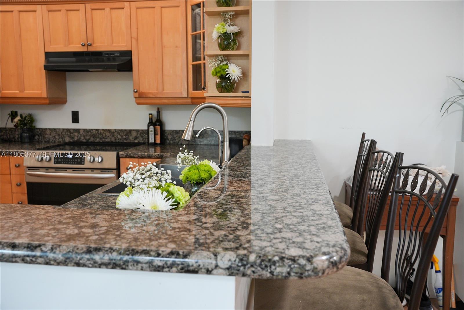 19663 Hampton Drive Boca Raton, FL 33434 - Photo 25 of 33 a kitchen with a stove a microwave a sink and a refrigerator